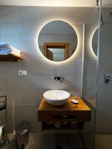 a bathroom with a sink and a mirror at Guesthouse Smogavc in Zreče