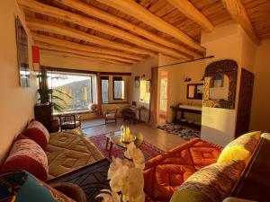 a living room with a couch and a table at Touda Ecolodge Atlas Mountains in Zawyat Oulmzi