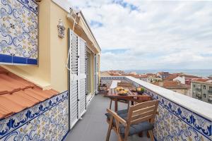 a balcony with a table and chairs on a building at Belle Vue sur le Tage in Lisbon