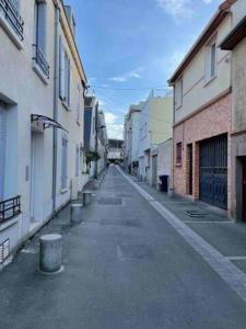 an empty street in an alley between buildings at WIFI- STADE DE FRANCE- BASILIQUE CATHEDRALE MONSEJOURASAINTDENIS in Saint-Denis