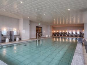a large swimming pool in a hotel room with a pool at Hotel Miyuki Beach in Onna