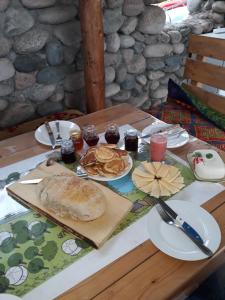 a table with a plate of food on it at Bel-Zhan Yurt Lodge in Grigor'yevka