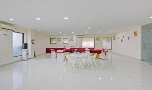 a large room with a table and chairs in it at Treebo Trend Amaya Inn Sector 72 in Noida
