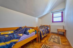 two bunk beds in a room with a window at Vila Nikola Zlatibor in Zlatibor
