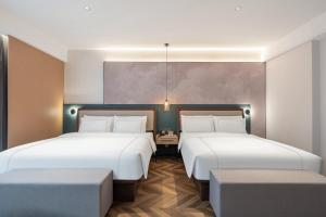 Postel nebo postele na pokoji v ubytování 银座佳悦精选酒店冠县冠宜春路店