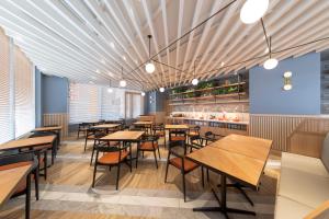 a dining room with wooden tables and chairs at Hotel Forza Nagoya Sakae in Nagoya