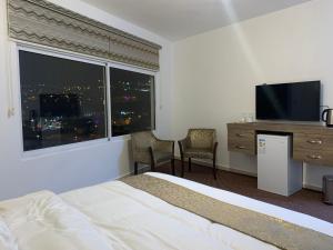 a hotel room with a bed and a large window at Asad Apt. in Wadi Musa