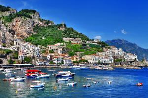 a group of boats in the water in front of a city at Dolce Vita A in Amalfi