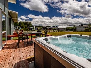 a hot tub on the deck of a house at Alpine Retreat - Ohakune Holiday Home in Ohakune