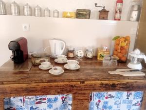 a kitchen counter with cups and saucers on it at casa thocamalu's in Covelo