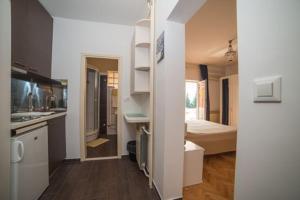 a room with a kitchen and a bedroom with a bed at Boutique B&B Villa Carmen in Mlini