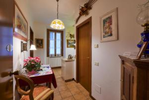 a dining room with a table with flowers on it at Casa di Mezzo "Historic centre of VARENNA" Lake Como in Varenna