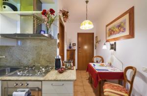 a kitchen with a sink and a table at Casa di Mezzo "Historic centre of VARENNA" Lake Como in Varenna
