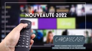 a person holding a remote control in front of a television at Kyriad Montpellier Ouest St Jean de Védas - A709 in Saint-Jean-de-Védas