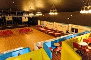 a view of a stage with tables and chairs at Pontins - Prestatyn Sands Holiday Park in Prestatyn