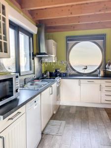 a kitchen with a sink and a window in it at AJ 09 - Villa "Le Hublot" in Ault