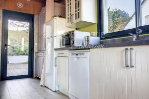 a kitchen with a white refrigerator and a window at AJ 09 - Villa "Le Hublot" in Ault