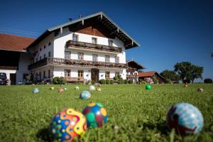 a house with balls in the grass in front of it at Naderbauer-Hof in Marquartstein
