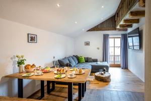 a living room with a table and a couch at Naderbauer-Hof in Marquartstein