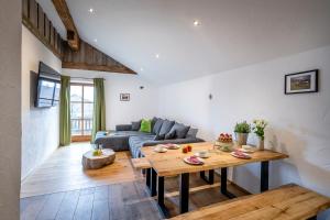 a living room with a couch and a table at Naderbauer-Hof in Marquartstein +18 photos