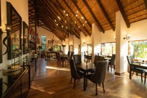 a dining room with tables and chairs in a restaurant at Karongwe Portfolio - Kuname Lodge in Hoedspruit