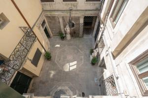 an overhead view of a courtyard in a building at Venice Palace Tintoretto by Wonderful Italy in Venice