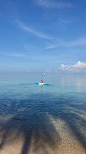 a person on a paddle board in the water at Jasmine & Tea House in Mae Nam