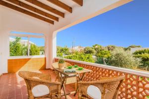 a patio with a table and chairs on a balcony at Villa Paula Punta Prima in Punta Prima