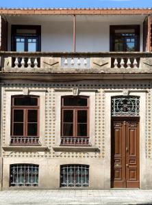 a facade of a building with a wooden door at 57 in Porto