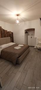 a bedroom with a bed and a wooden floor at Tresca Vecchia in Bari +15 photos