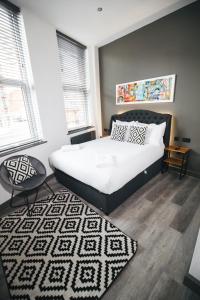 a bedroom with a large bed and a rug at Black Lion Hotel in Manchester