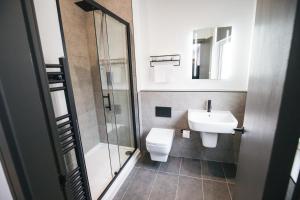 a bathroom with a toilet and a sink and a shower at Black Lion Hotel Manchester in Manchester