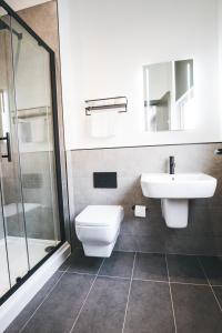 a bathroom with a toilet and a sink and a shower at Black Lion Hotel in Manchester