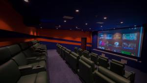 a cinema room with chairs and a large screen at Litz Resort in Kvariati
