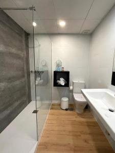 a bathroom with a shower and a toilet and a sink at FAY Victoria Beach in Rincón de la Victoria