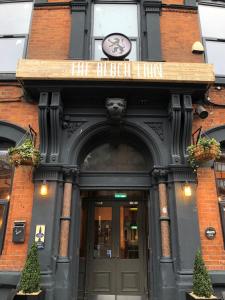 an entrance to a building with a clock above the door at Black Lion Hotel in Manchester