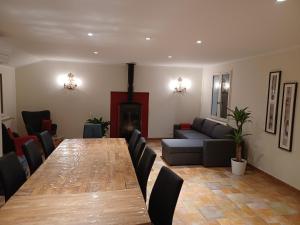 a living room with a long table and a couch at Comorebi Provence in Entrecasteaux