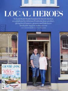 un hombre y una mujer parados en la puerta de un edificio en St Davids Gin & Kitchen - The Cathedral Villas, en St. Davids