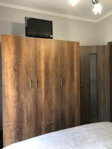 a bedroom with a tv on top of a wooden cabinet at The only luxurious apartment in the center of town in Kilkís