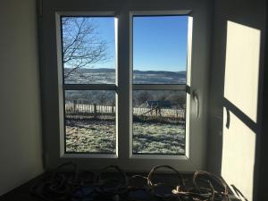 a window with a view of a snow covered field at La Maison de Julienne - Ligneuville in Malmedy