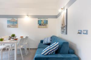 sala de estar con sofá azul y mesa en La Casa Di Tobia Central Flat near the Sea en Giardini Naxos