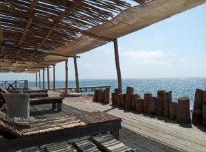 a wooden deck with a view of the ocean at Centro Ubuntu in Isla Grande
