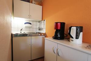 a kitchen with a sink and a coffee maker on a counter at Ferienhaus Beyer in Kühlungsborn