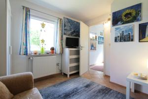 a living room with a couch and a window at Ferienhaus Beyer in Kühlungsborn