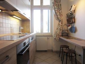 a kitchen with a sink and a counter with stools at Ferienwohnung Seeadler Nr. 7 in Kühlungsborn +12 photos
