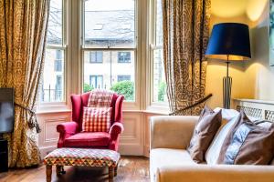 a living room with a couch and a chair and a window at 7 St John's Crescent in York