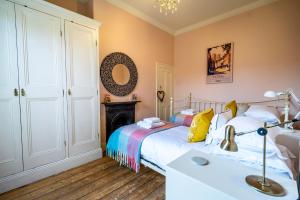 a bedroom with a bed and a mirror at 7 St John's Crescent in York