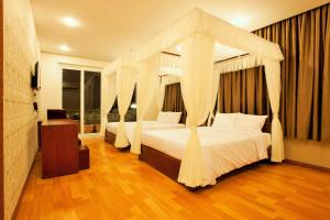 Giường trong phòng chung tại Anh Dao Mekong 2 Hotel