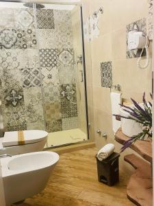 a bathroom with a toilet and a glass shower at Granoro Gragnano B&B in Gragnano +55 photos