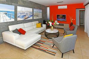 a living room with a white couch and chairs at Salobre Par 4 No6 in Salobre